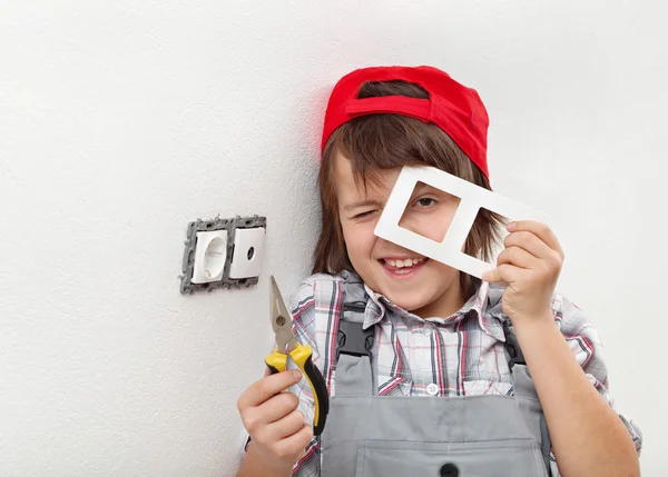전기 벽 고정 장치를 분해 하는 어린 소년 — 스톡 사진