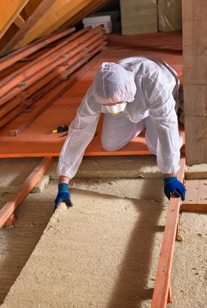Man laying thermal insulation layer - wearing protective clothin — Stock Photo, Image