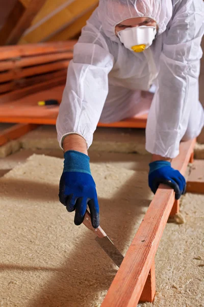 Man laying thermal insulation layer on building — Stock Photo, Image