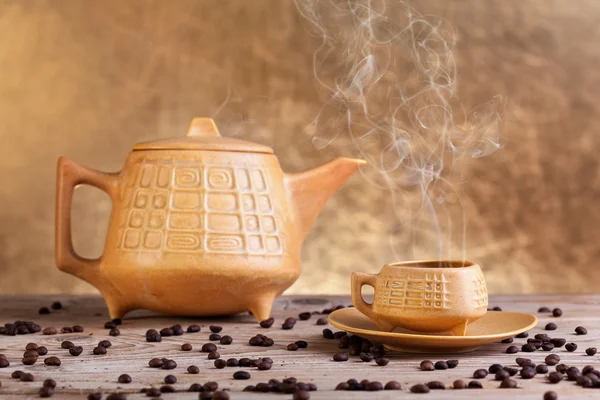 Steaming coffee on wooden table — Stock Photo, Image