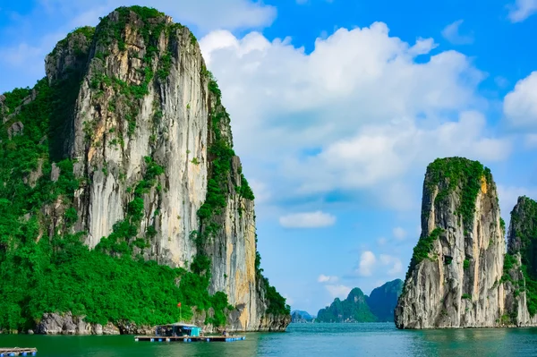 Rock islands near floating village in Halong Bay — Stock Photo, Image