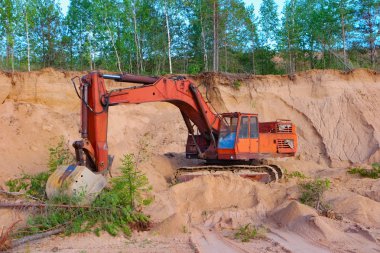 Excavator working in sand quarry clipart