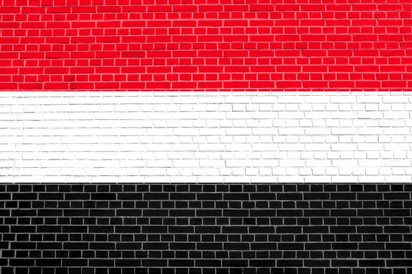 Bandiera dello Yemen su sfondo texture muro di mattoni — Foto Stock