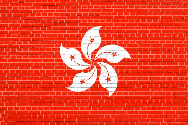 れんが造りの壁テクスチャ背景に香港の旗 — ストック写真
