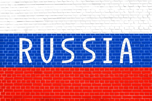 Ρωσική σημαία και λέξη Ρωσία στον τοίχο από τούβλα — Φωτογραφία Αρχείου