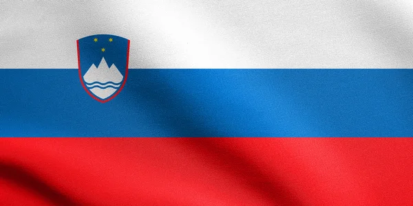 Sloveniens flagga vifta med tyg konsistens — Stockfoto