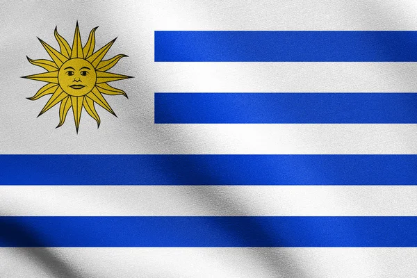 Flagge von Uruguay weht mit Stoffstruktur — Stockfoto