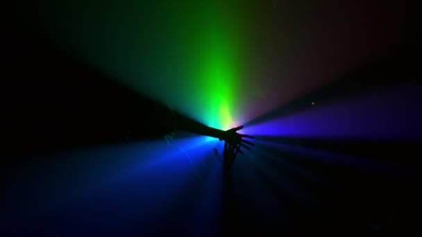 Projecteur. Connexion symbolique de trois mains de personnes différentes dans des rayons de lumière multicolores. — Video