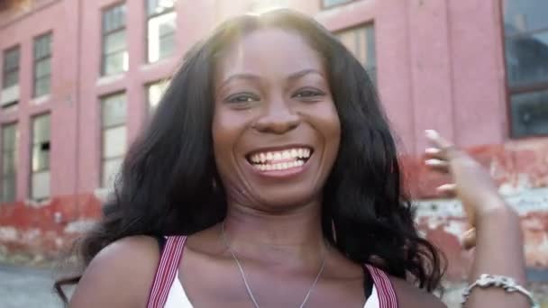 Sorrindo jovem menina negra no fundo da construção. — Vídeo de Stock