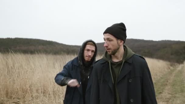 Two Friends Walking On The Road In The Field. They Jokingly Fight. — Stock Video