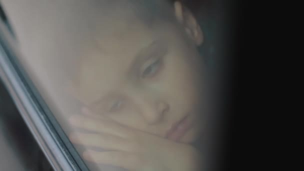 Boy Face In Car. Upset Boy Looking Out The Window. The Car Goes — Stock Video