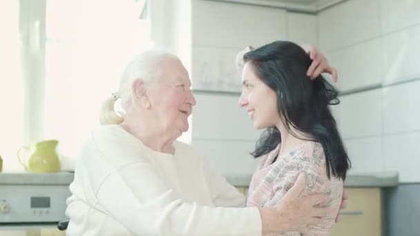 Old Woman Hugging Her Young Granddaughter. Woman In The Kitchen. Women Are Talking. — Stock Video