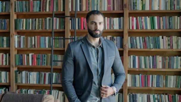 Serious Young Oriental Man Standing In The Library. — Stock Video