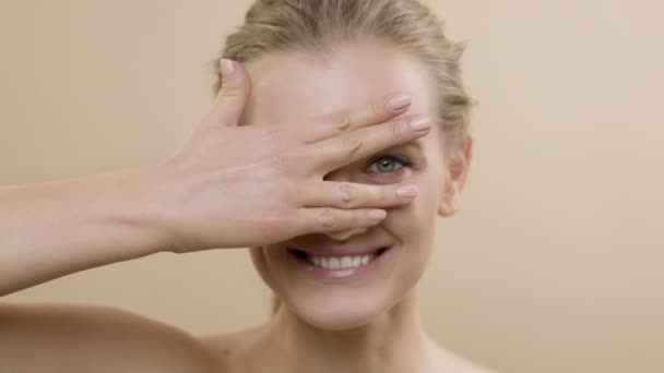 Arca Stílusos Fiatal Modell Gyönyörű Skin.She Takarta arcát a tenyerével, és nézett át a rést az ujjai között. — Stock videók