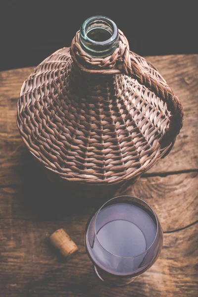 Wine carboy and wine glass — Stock Photo, Image