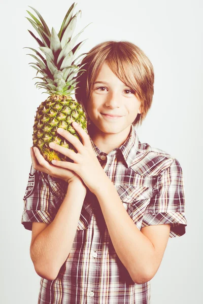 Child with fresh pineapple — Stock Photo, Image