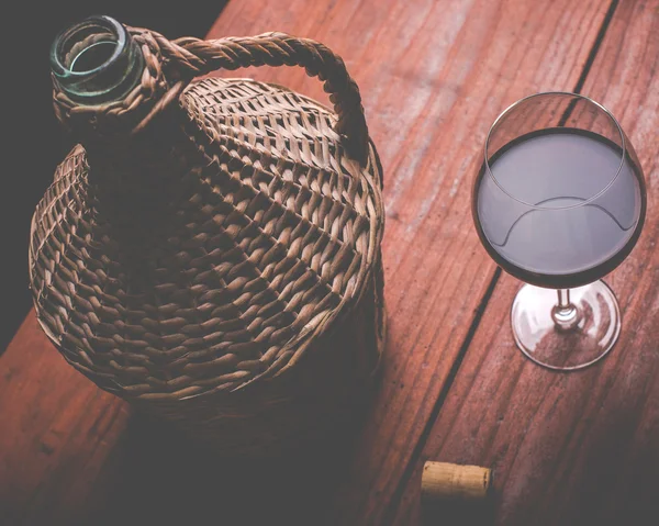 Wine carboy and wine glass — Stock Photo, Image