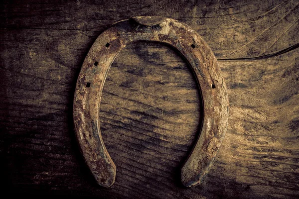 Horseshoe on old wood — Stock Photo, Image