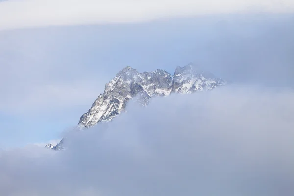 Cima di montagna nel cielo basato su nuvole — Foto Stock