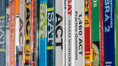 Detroit, Michigan - December 12, 2020 : Row of ACT and SAT books contain standardized practice tests for university admissions in USA.  clipart