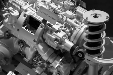 Automotive engine showing Supercharger and turbo charger in monochrome.