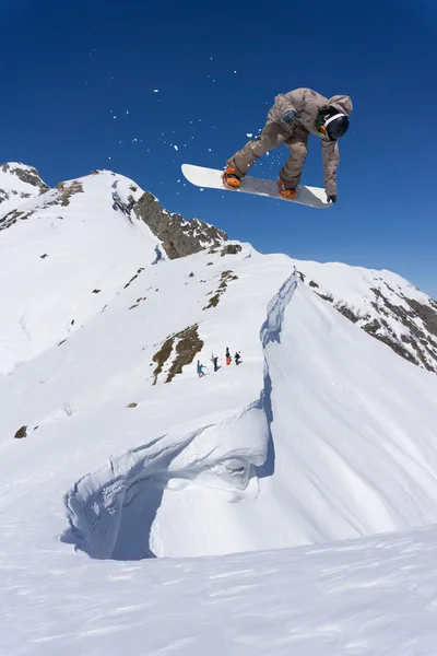 Latający snowboardzista w górach. Sporty ekstremalne. — Zdjęcie stockowe