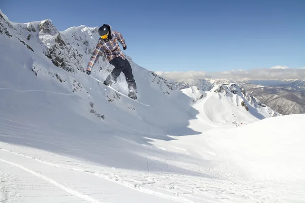 Vliegende snowboarder op de bergen. Extreme sport. — Stockfoto