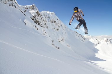 Dağlarda uçan snowboardcu. Sıra dışı spor.