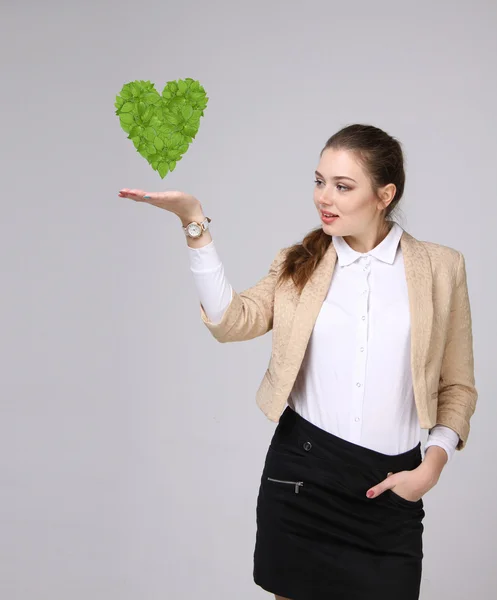 Mujer sosteniendo corazón de planta verde en sus manos — Foto de Stock