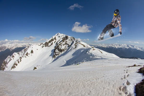 Snowboardzista skoki na góry. Sport ekstremalny. — Zdjęcie stockowe