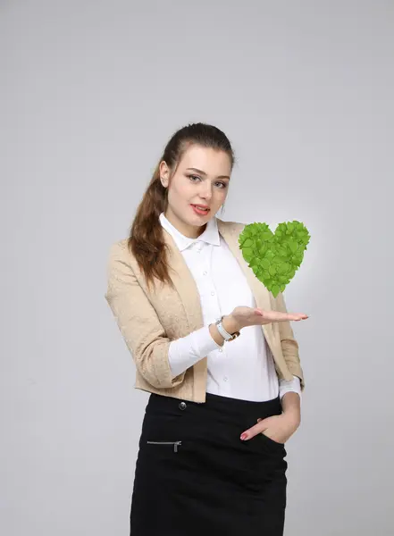 Vrouw met groene plant hart in haar handen — Stockfoto