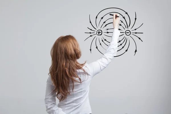 Genç kadın, fizik öğretmeni bir diyagram elektrik alanının çizer. — Stok fotoğraf