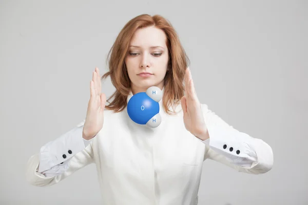 Young woman scientist with model of water molecule. — Stock Photo, Image
