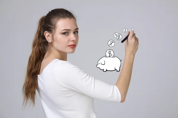 Jonge vrouw tekenen een piggy Bank — Stockfoto