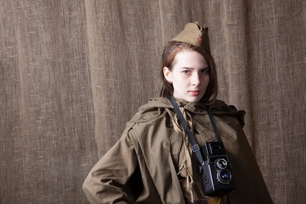 Woman in Russian military uniform with camera. Female war correspondent during the second world war.