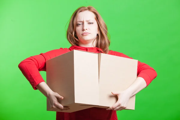 Woman holding cardboard boxes on green background — Stock Photo, Image