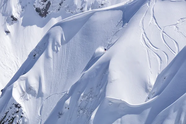 Snowboard freeride, snowboarders and tracks on a mountain slope. Extreme winter sport. — Stock Photo, Image