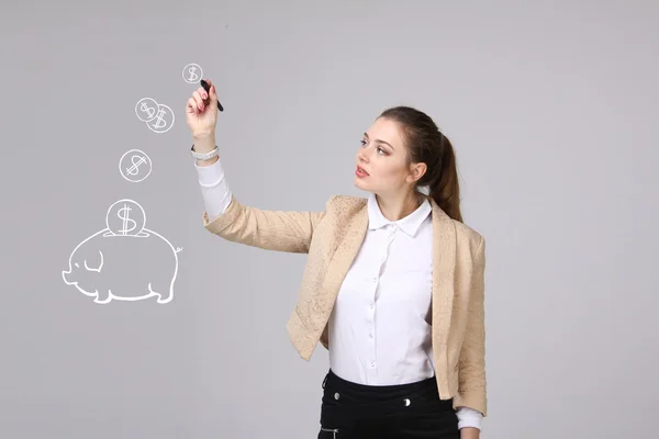 Young woman drawing a piggy Bank — Stock Photo, Image