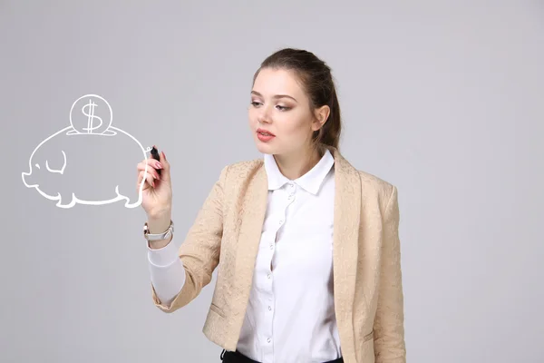 Young woman drawing a piggy Bank — Stock Photo, Image