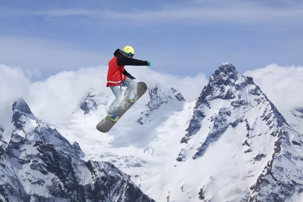 Snowboard lovas ugrál a hegyekben. Extrém snowboard freeride sport. — Stock Fotó