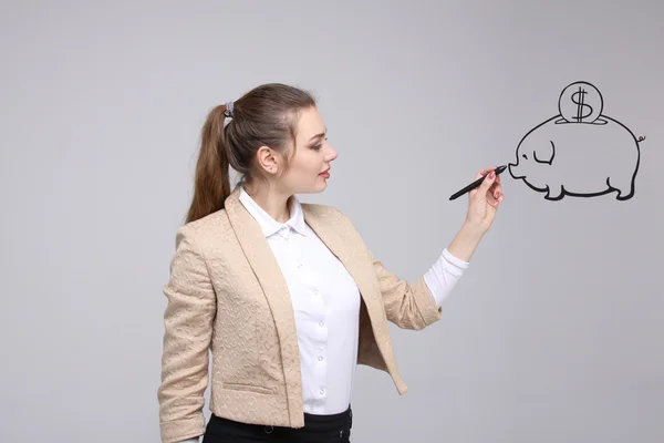 Young woman drawing a piggy Bank — Stock Photo, Image