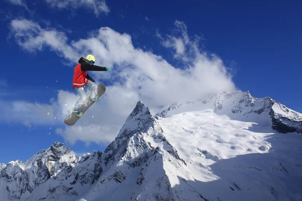 Snowboard rider saltando en las montañas. Extremo snowboard freeride sport. — Foto de Stock