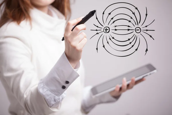 Mujer joven, profesora de física dibuja un diagrama del campo eléctrico — Foto de Stock