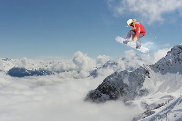 スノーボードライダー山の上でジャンプします。極端なスノーボードフリーライドスポーツ. — ストック写真