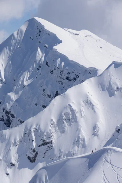 Snowboard freeride, snowboarders and tracks on a mountain slope. Extreme sport.