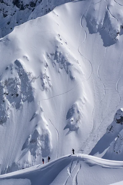 Snowboard freeride, snowboarders and tracks on a mountain slope. Extreme sport. — Stock Photo, Image