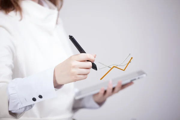 Businesswoman working with growth graph on grey background — Stock Photo, Image