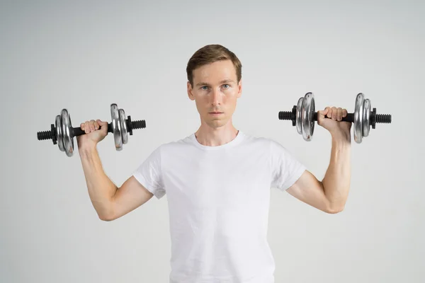 Young Man doing Exercise with Dumbbells. — Stock Photo, Image