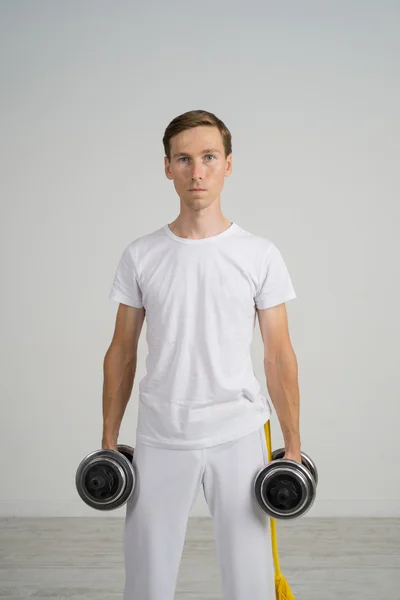 Young Man doing Exercise with Dumbbells. — Stock Photo, Image