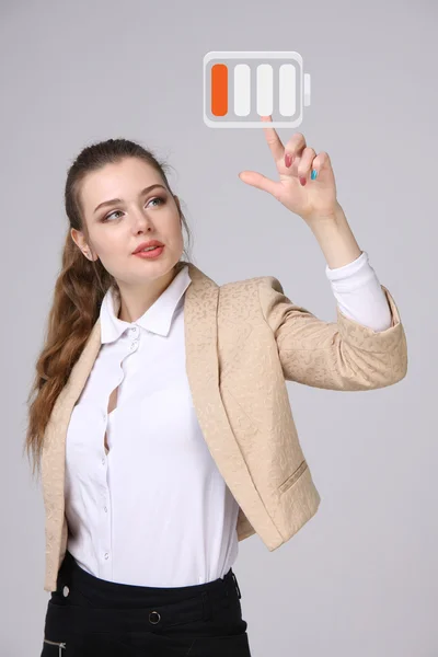 Young Businesswoman and battery level icon — Stock Photo, Image